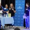 Members of the Student Affairs "Improvement Aviators" team presenting their process improvement project at the Process Improvement & Lean Operations (PILOT) Year-End Showcase, with one team member speaking while others participate in the presentation.