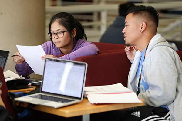CSUSB students studying on laptops.
