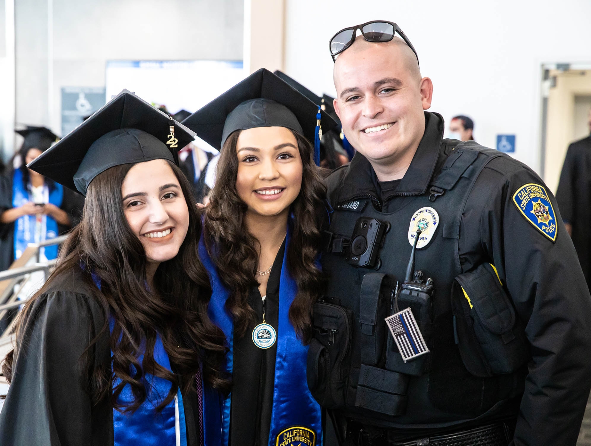 Officer John Taitano (right) poses with two graduating students at the 2022 Latinx Graduation Recognition Ceremony.