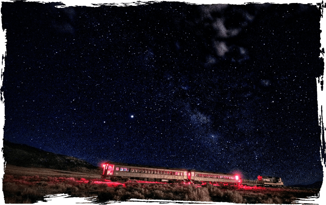 train on tracks with stary sky above