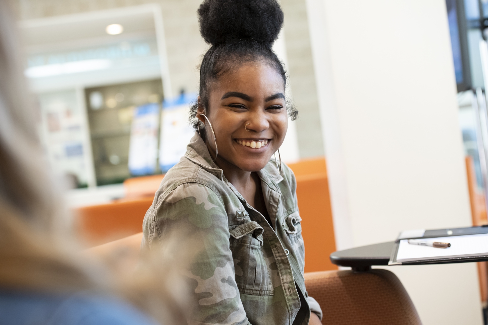 Student smiling during conversation.