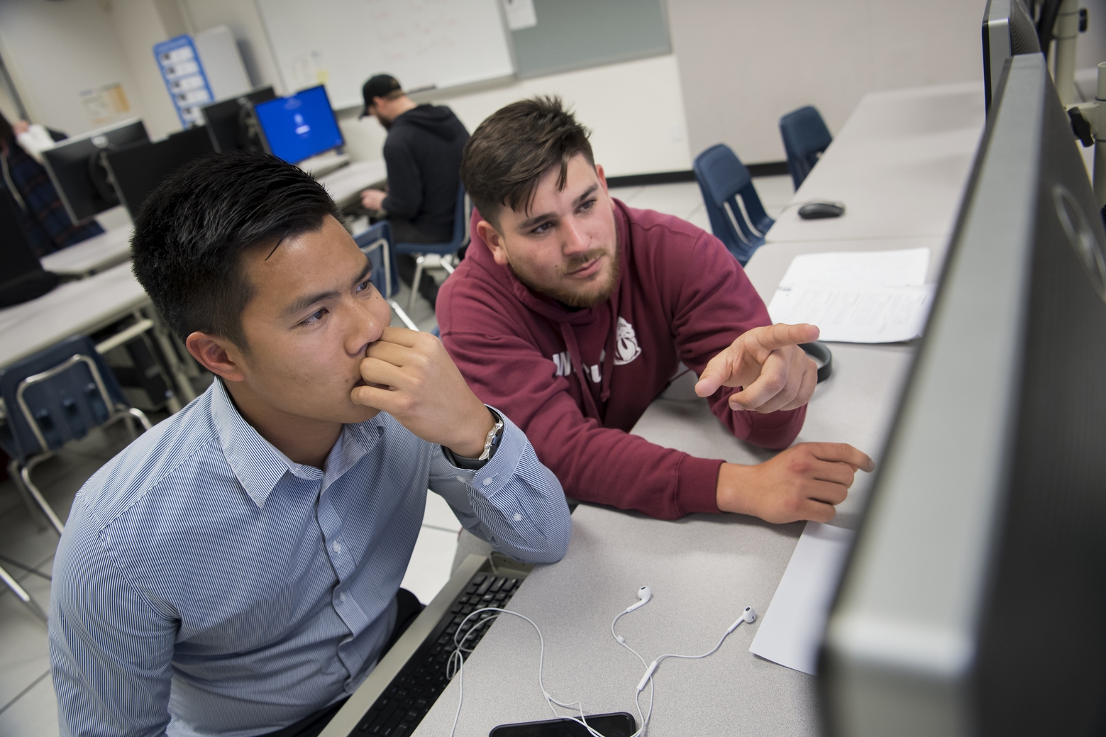 Students sitting at a computer.