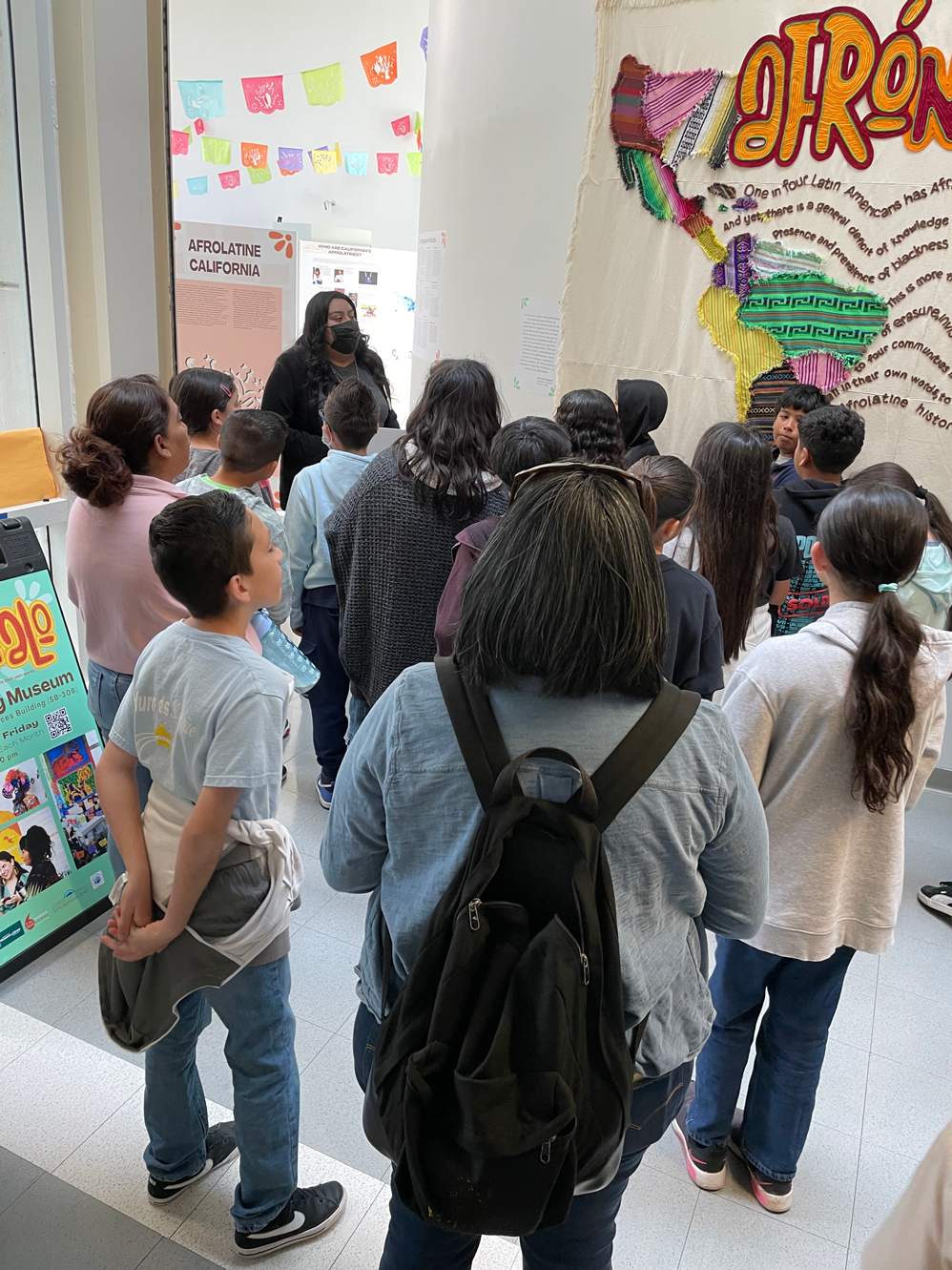 Students experience “Afróntalo,” which is on display at the Anthropology Museum through June 19.