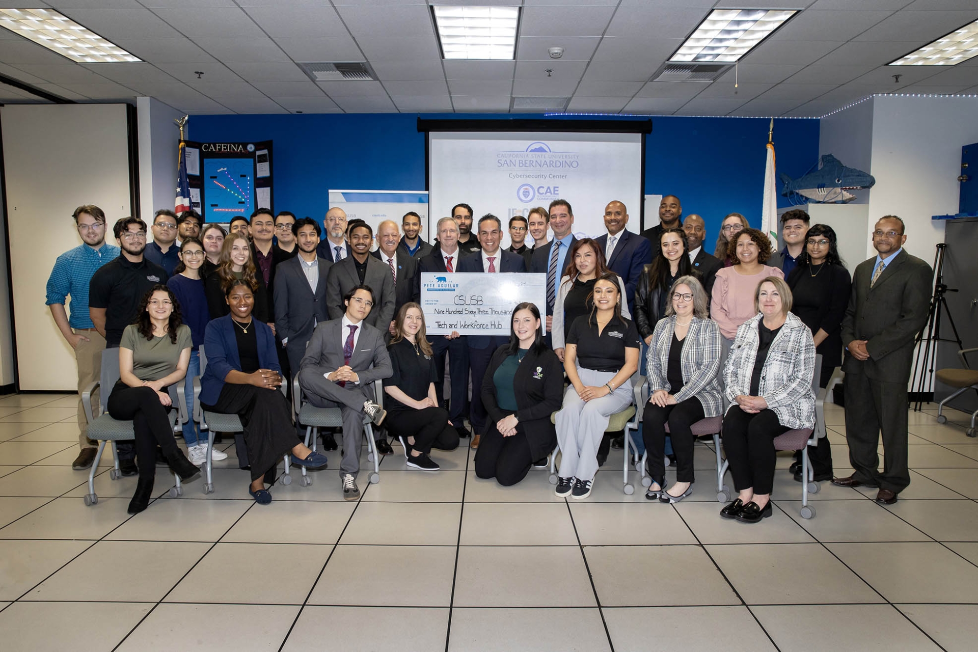 Students, faculty, staff and university administrators with U.S. Rep. Pete Aguilar (holding the ceremonial check) at the CSUSB Cybersecurity Center.