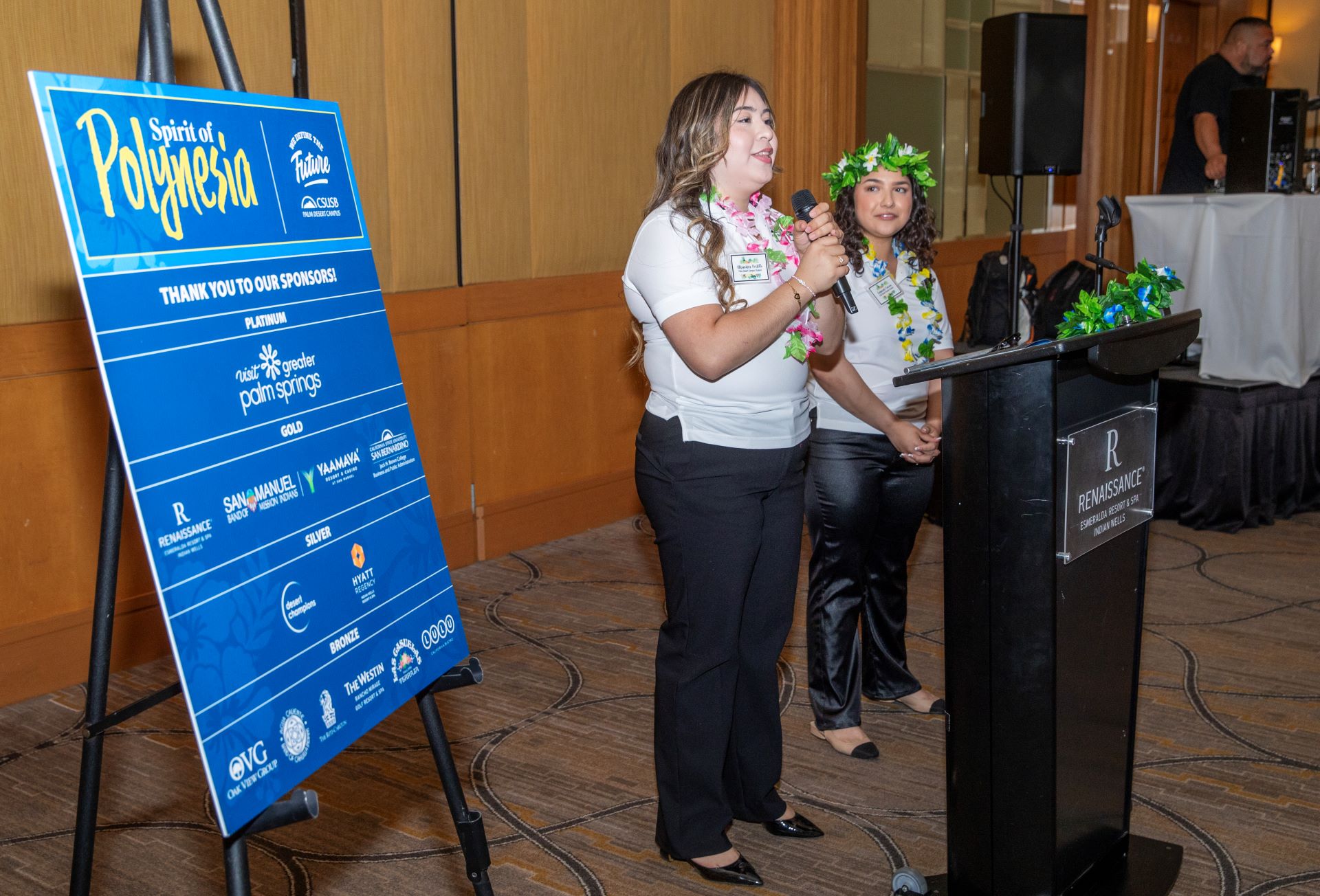 Hospitality management students Alejandra Portillo and Evyanah Camp provide opening remarks at the gala.