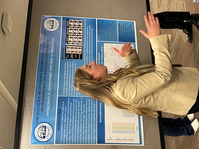 Natalya Marsh explains her study, published in the journal Frontiers, to an interested visitor. Her research explores how attitudes towards police might influence the interpretation of police officers' emotional expressions.