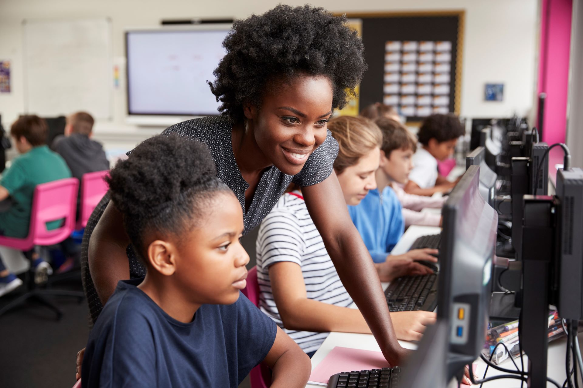 Female teacher assisting a student.