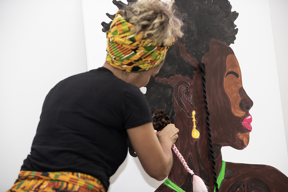 An artist making art at Natural Hair Day. 