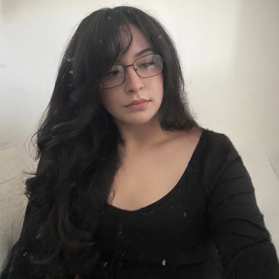 Image of a female with glasses looking away from the camera.