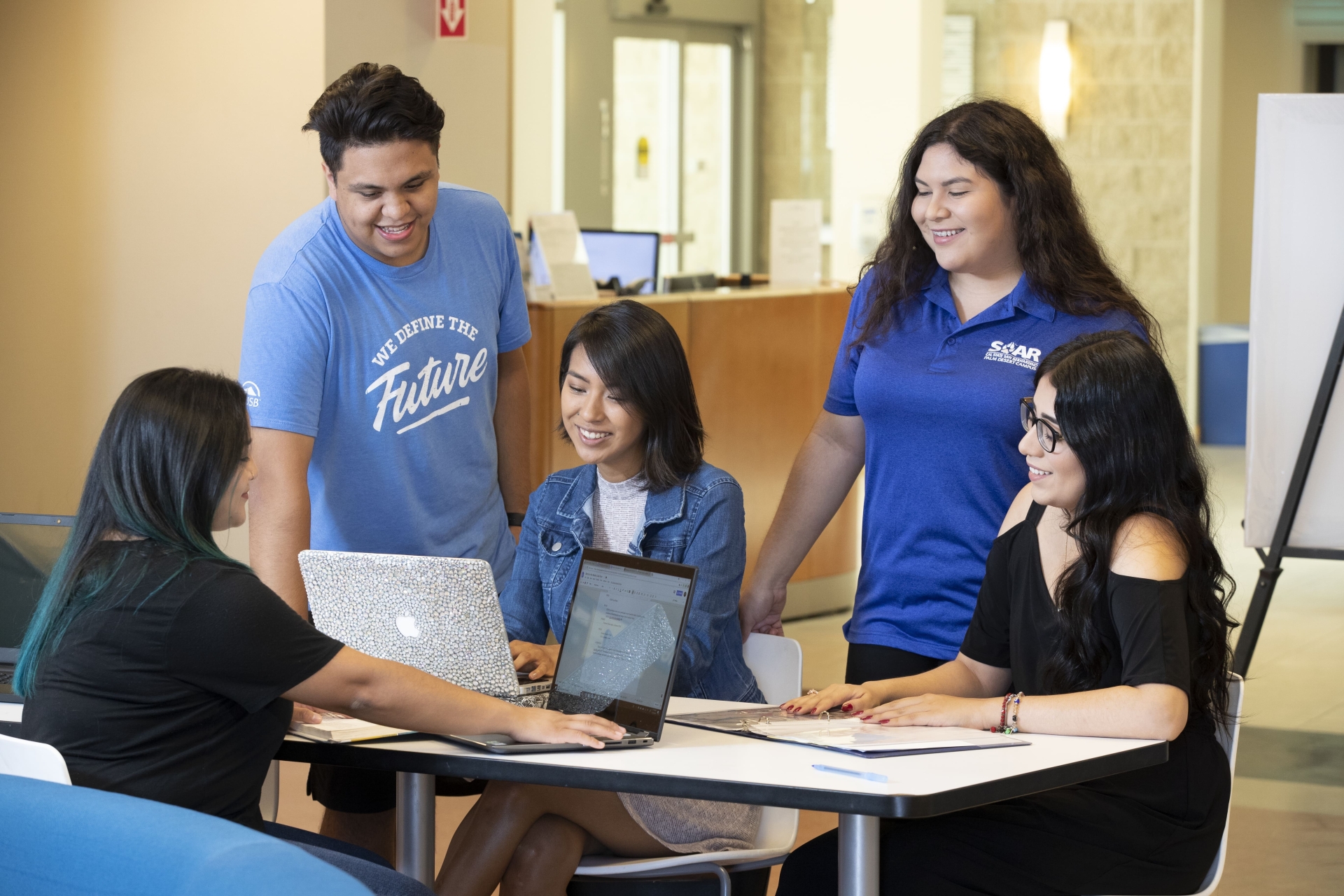 Students mentoring peers at table