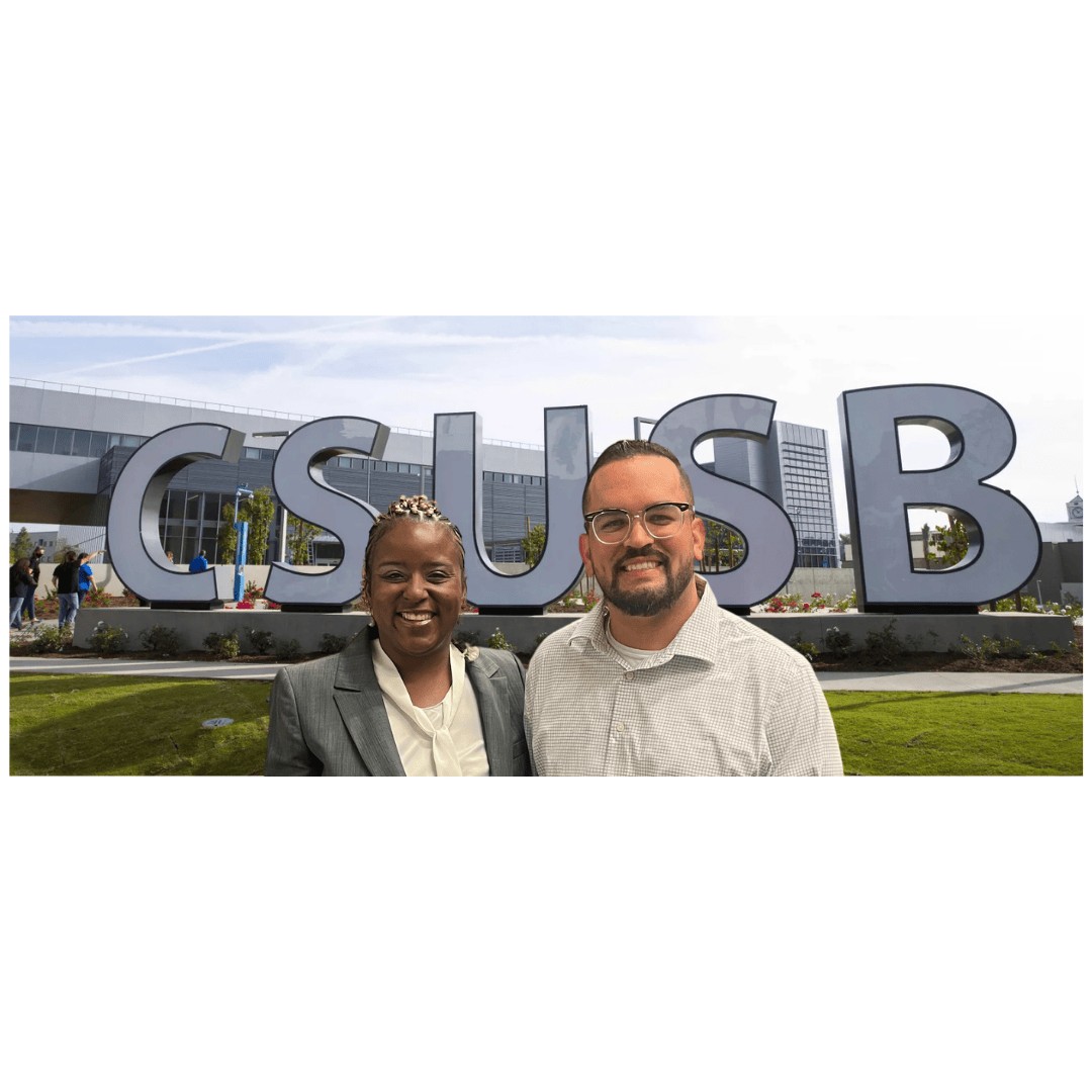 Dr. Anderson and Michael Griggs Standing in front of the CSUSB signage