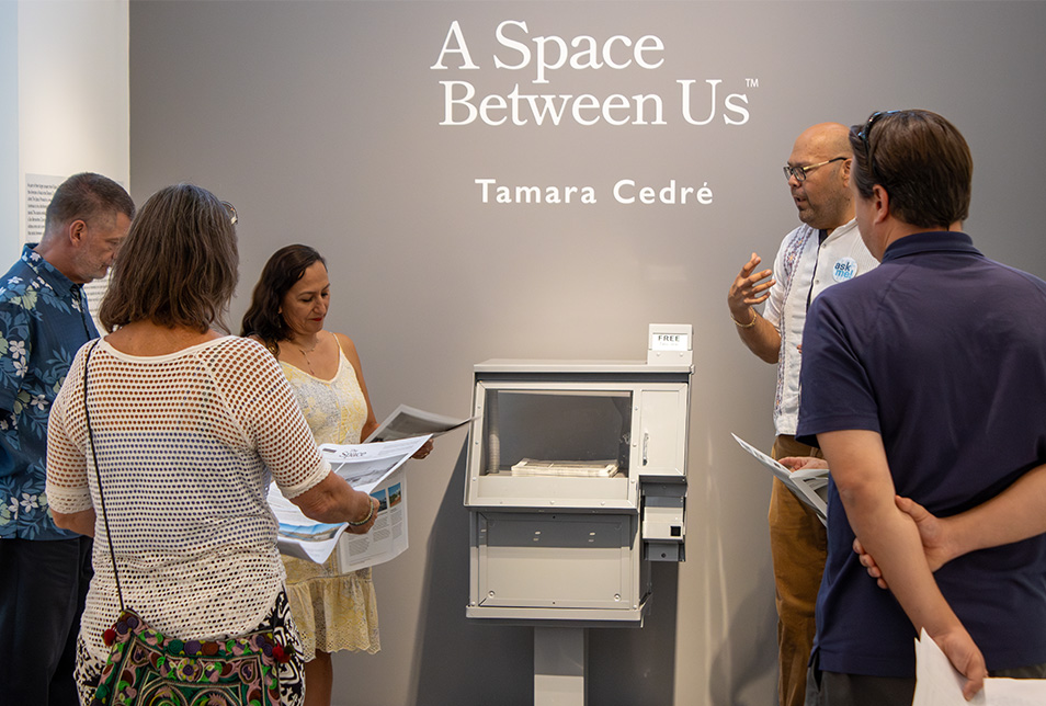 A group stands in front of a newsstand conversating
