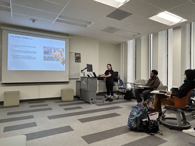 lucy giving a presentation about Mural workshop