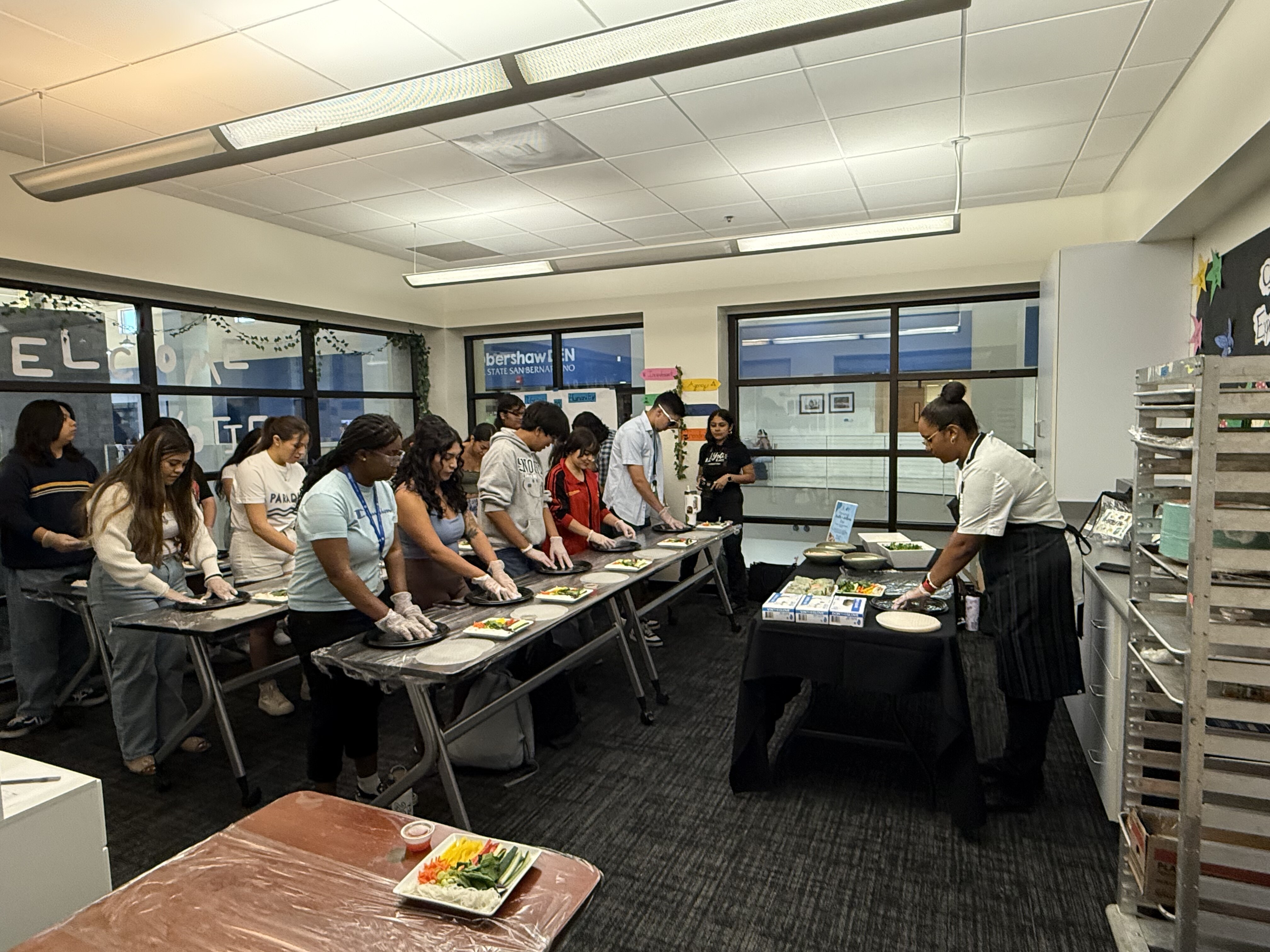 Students learning how to make spring rolls