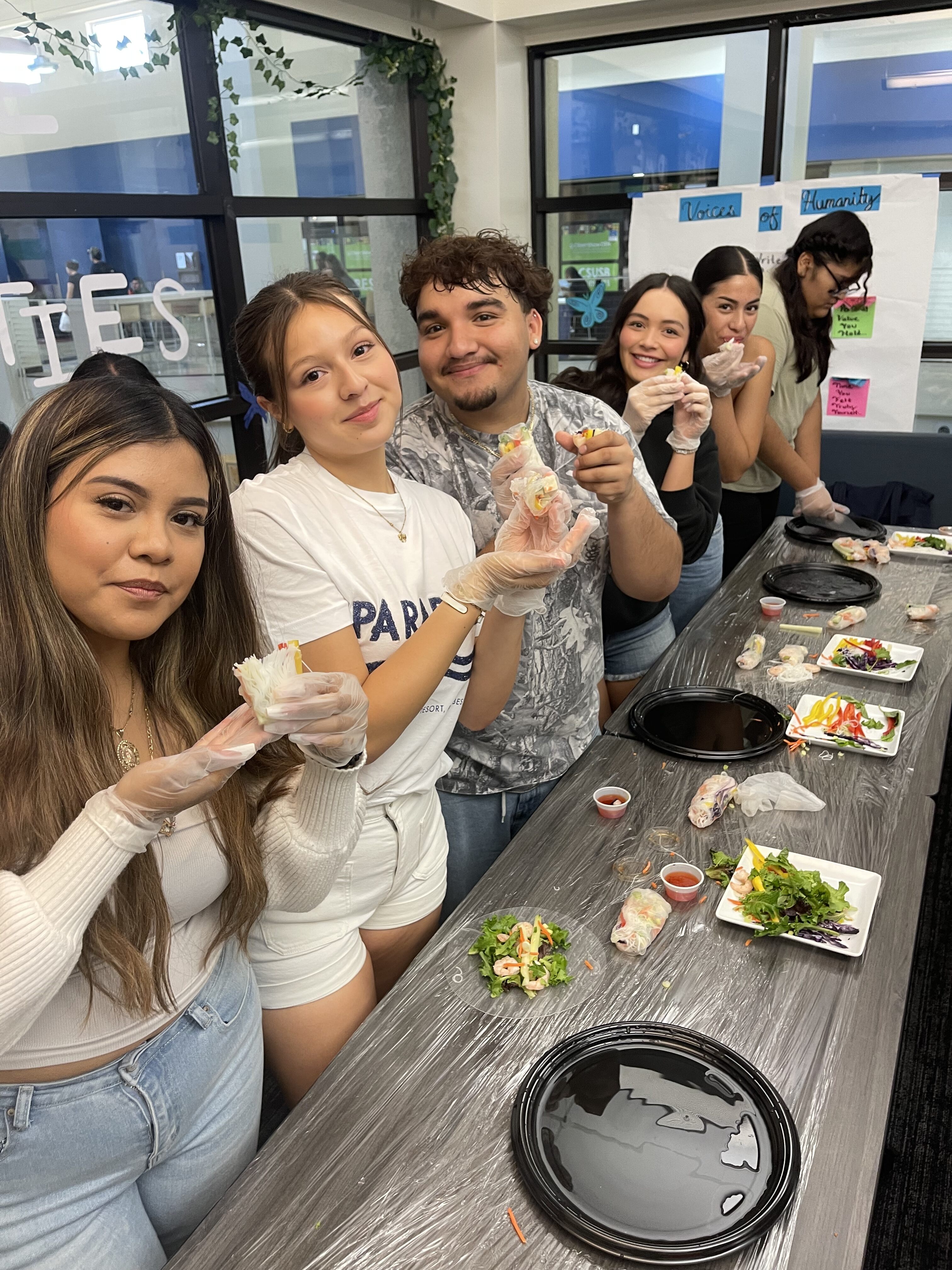 Students learning how to make spring rolls