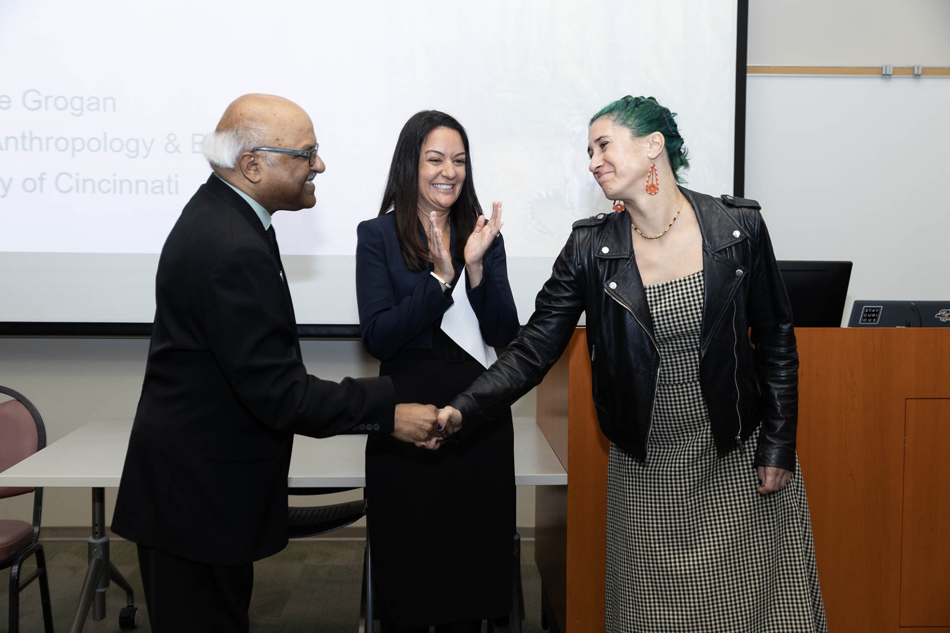 Sastry Pantula, dean of the College of Natural Sciences, congratulates Lúa Lopez-Perez, recipient of the 2024-25 Outstanding Faculty Advisor Award, as Kelly Campbell, vice provost, looks on.