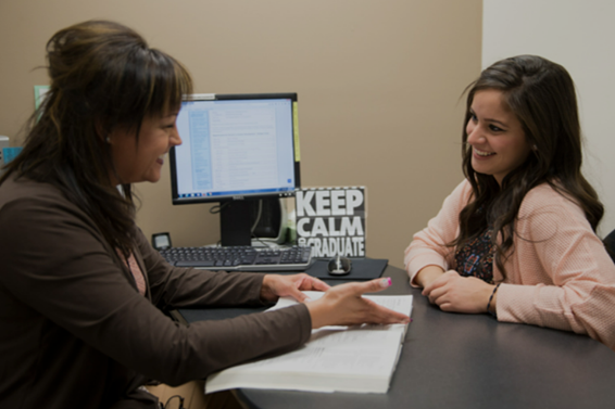 student talking to advisor in a office