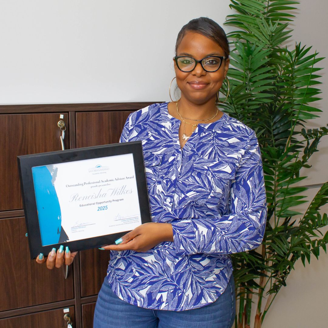 Picture of award winner holding a plaque