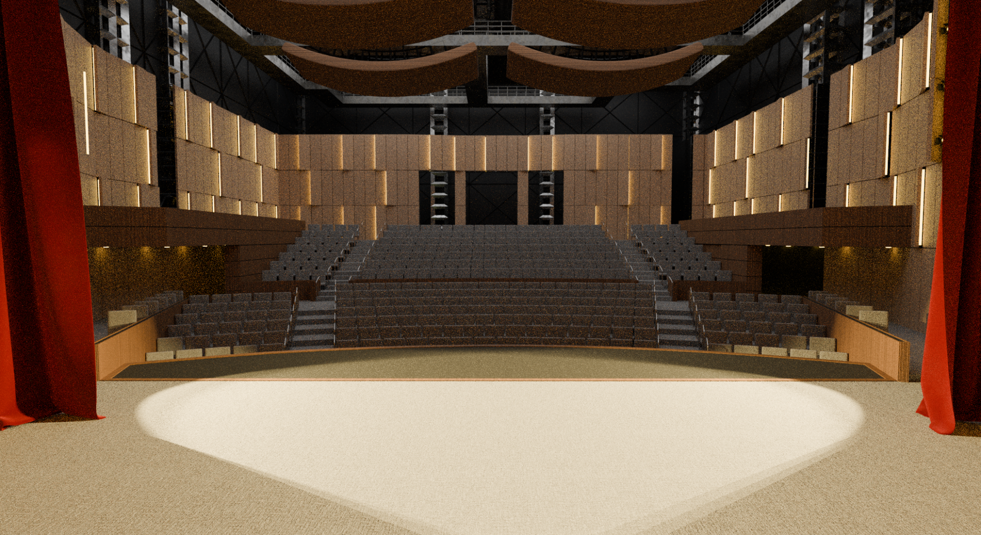 View from the stage looking out into a modern auditorium with tiered seating. The space includes warm wood paneling, acoustic treatments on the walls, overhead rigging for stage equipment, and red curtains framing the stage.