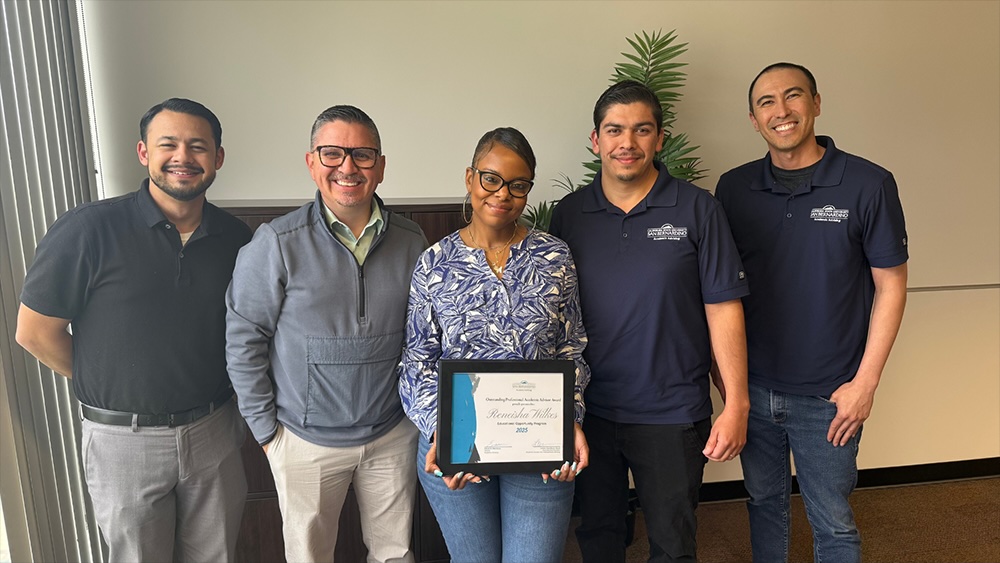 From left, John Noriega, academic advisor and undeclared advising coordinator; Eduardo Mendoza, director of academic advising; Wilkes; Arturo Gutierrez, academic advisor; and Matt Markin, academic advisor and academic success coordinator.
