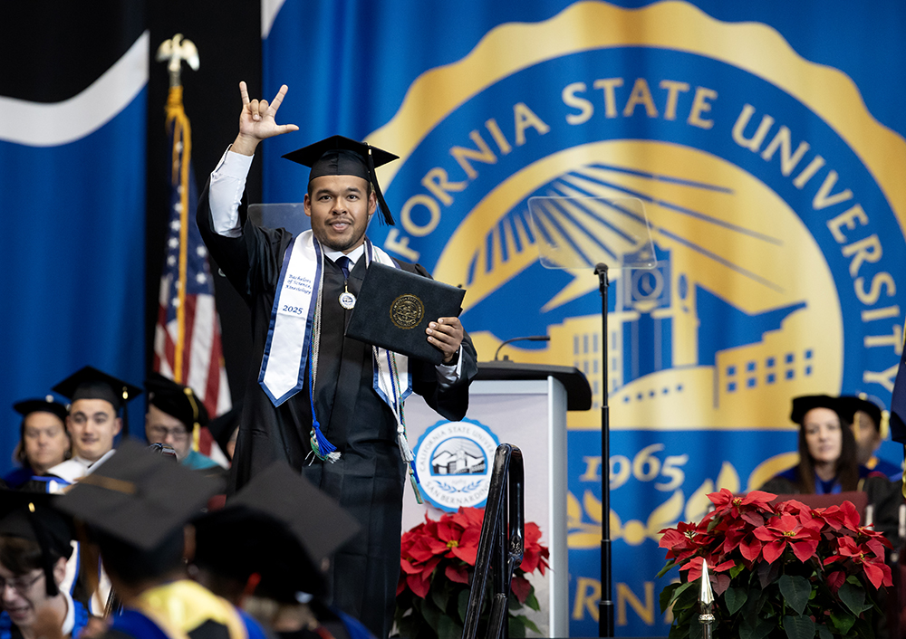 A graduate celebrates earning his degree at the College of Natural Sciences’ commencement ceremony.