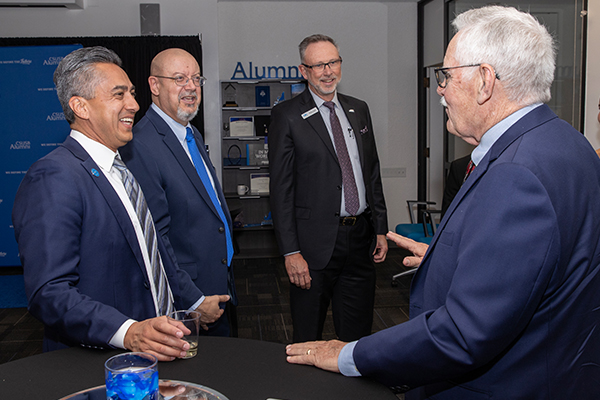 Paw Print Award recipient Harp (far right) chats with, from left, Vivian; Tomás Gomez-Arias, dean of the Jack H. Brown College of Business and Public Administration; and Zach Tucker, senior director of philanthropy.