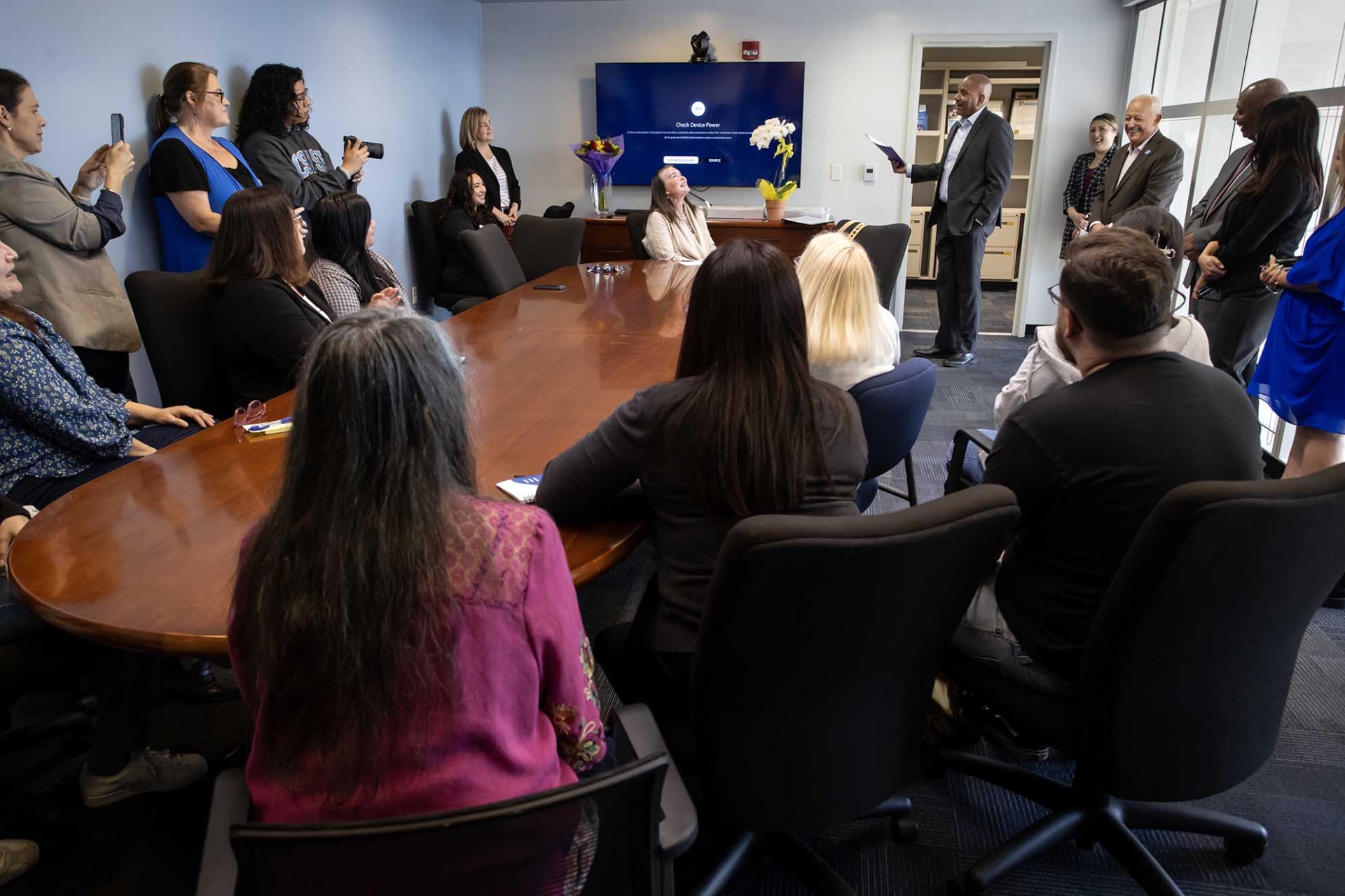 Students, faculty, administrators and staff gathered on the fourth floor of the College of Social and Behavioral Sciences building as President Tomás D. Morales announces that Rachel Estrada is the 2024-25 Outstanding Lecturer Award recipient.