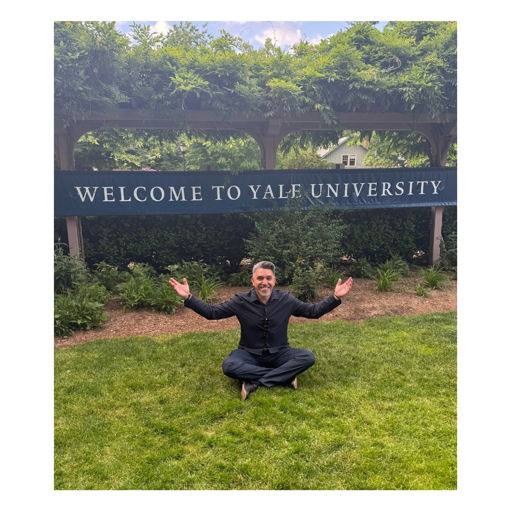 Picture of Luis Trujillo in front of a banner that says, Welcome to Yale University.