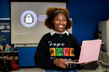 Student holding laptop
