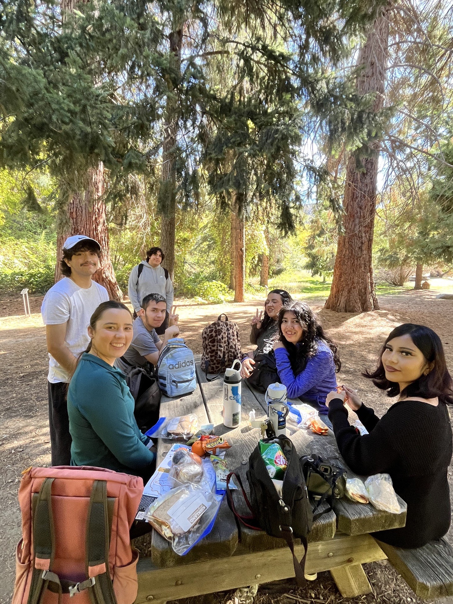 group at picni table under oak trees