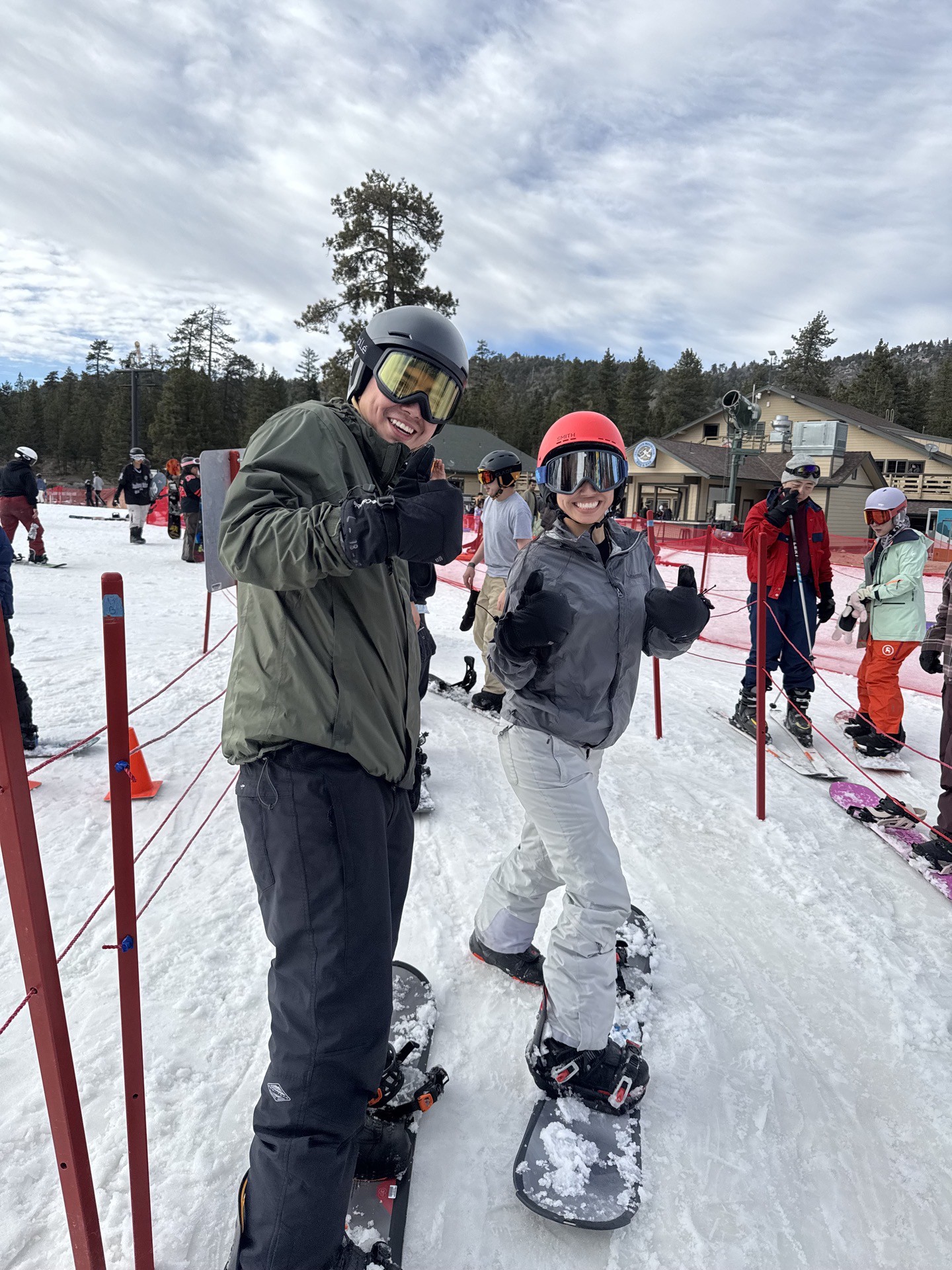 2 snowboarders in line for lift