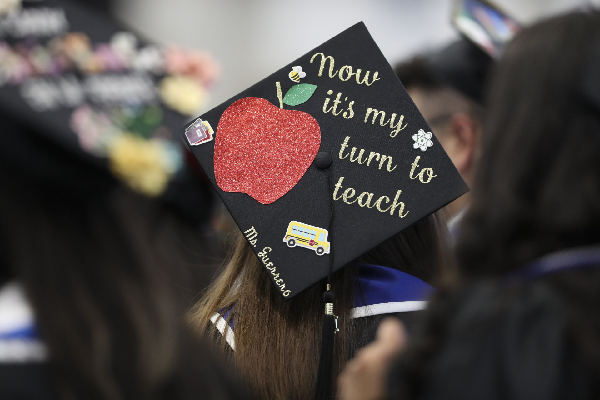Graduation picture shows "Now it's my turn to teach"