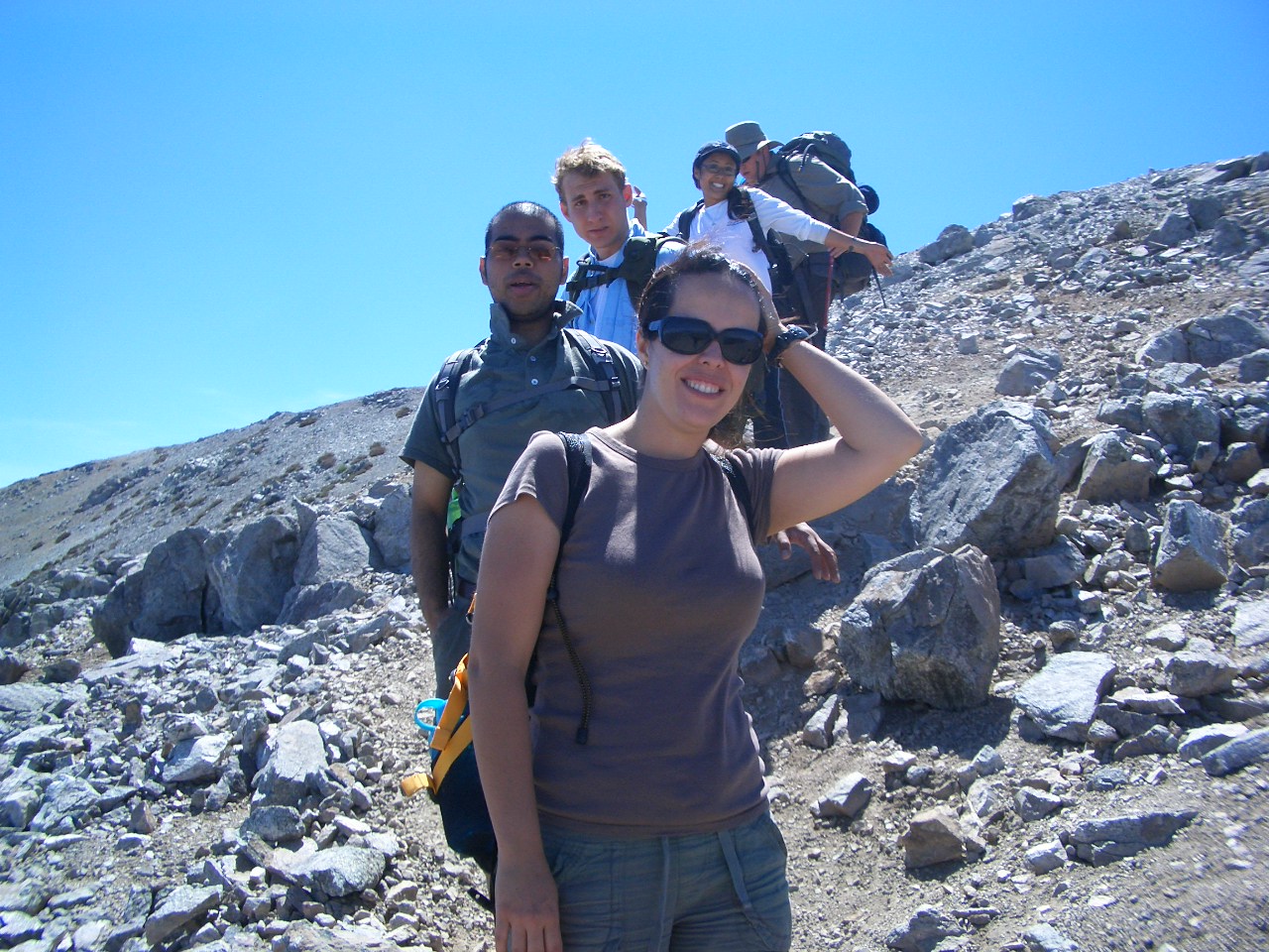 group hiking down rock slope