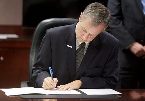 Man filling out paperwork by hand