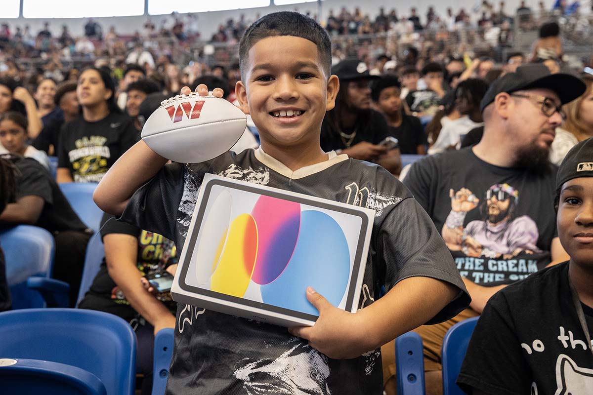 A young fan who won a tablet during the Jayden Daniels Community Day event at CSUSB.