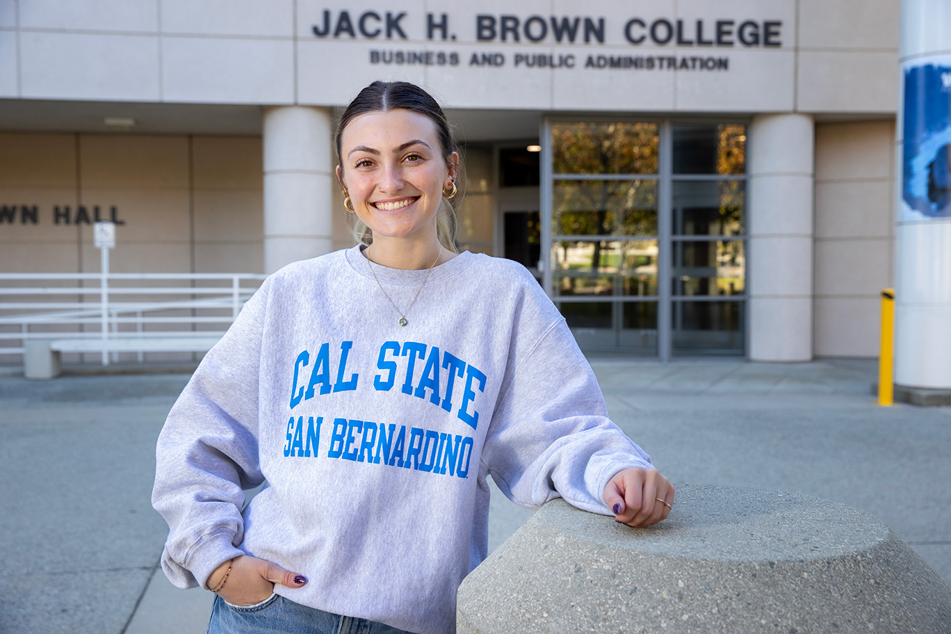 Student in front of Jack H, Brown College