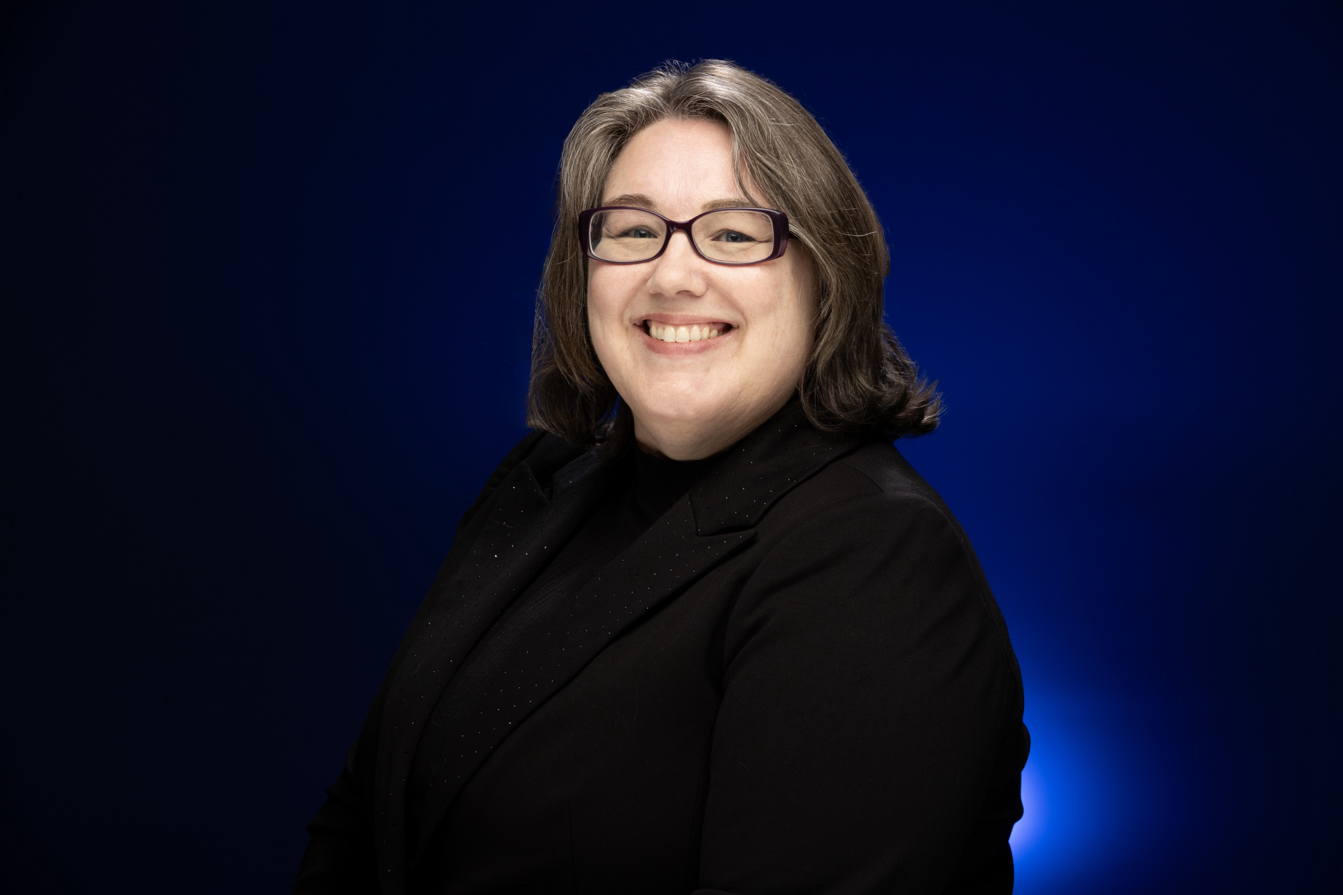 Image of Dr. Jessica Getman in front of a blue and black background