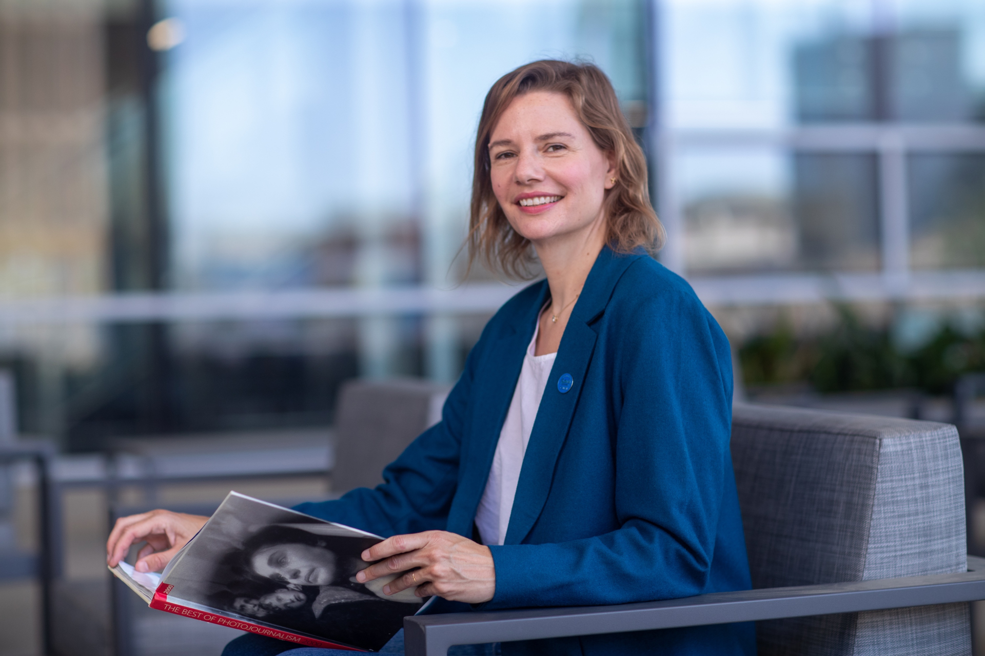 Dr. Erin Hall sitting outside the Center for Global Innovation, smiling