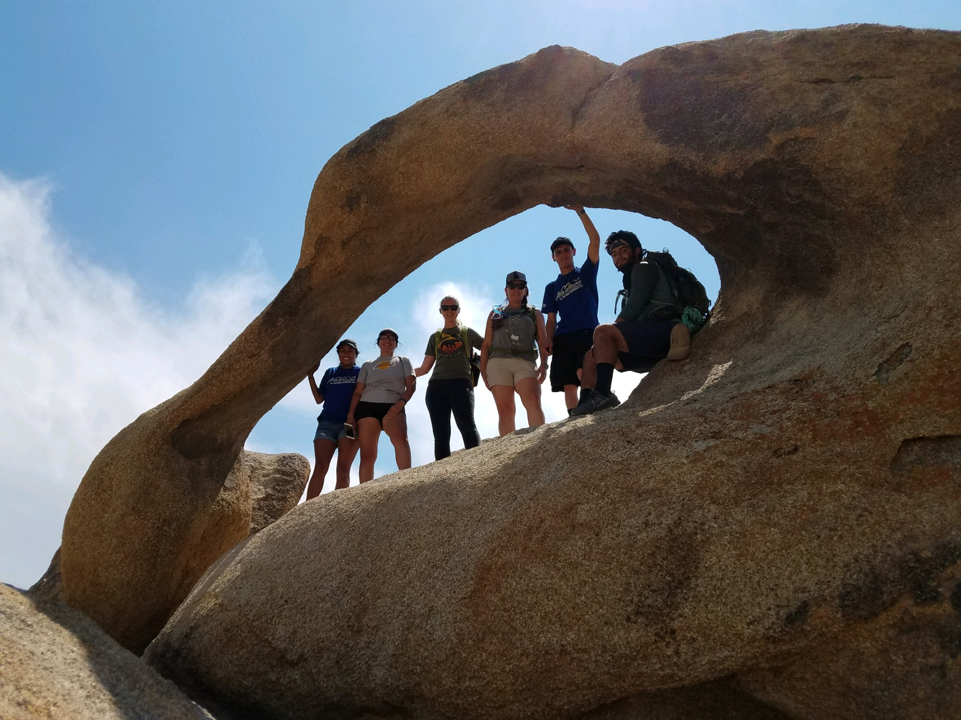 group under rock arch