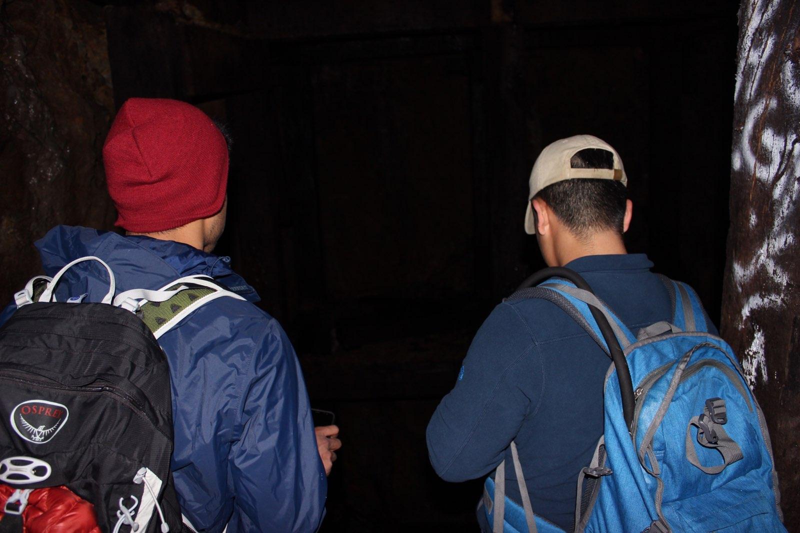 2 people walking into a mine