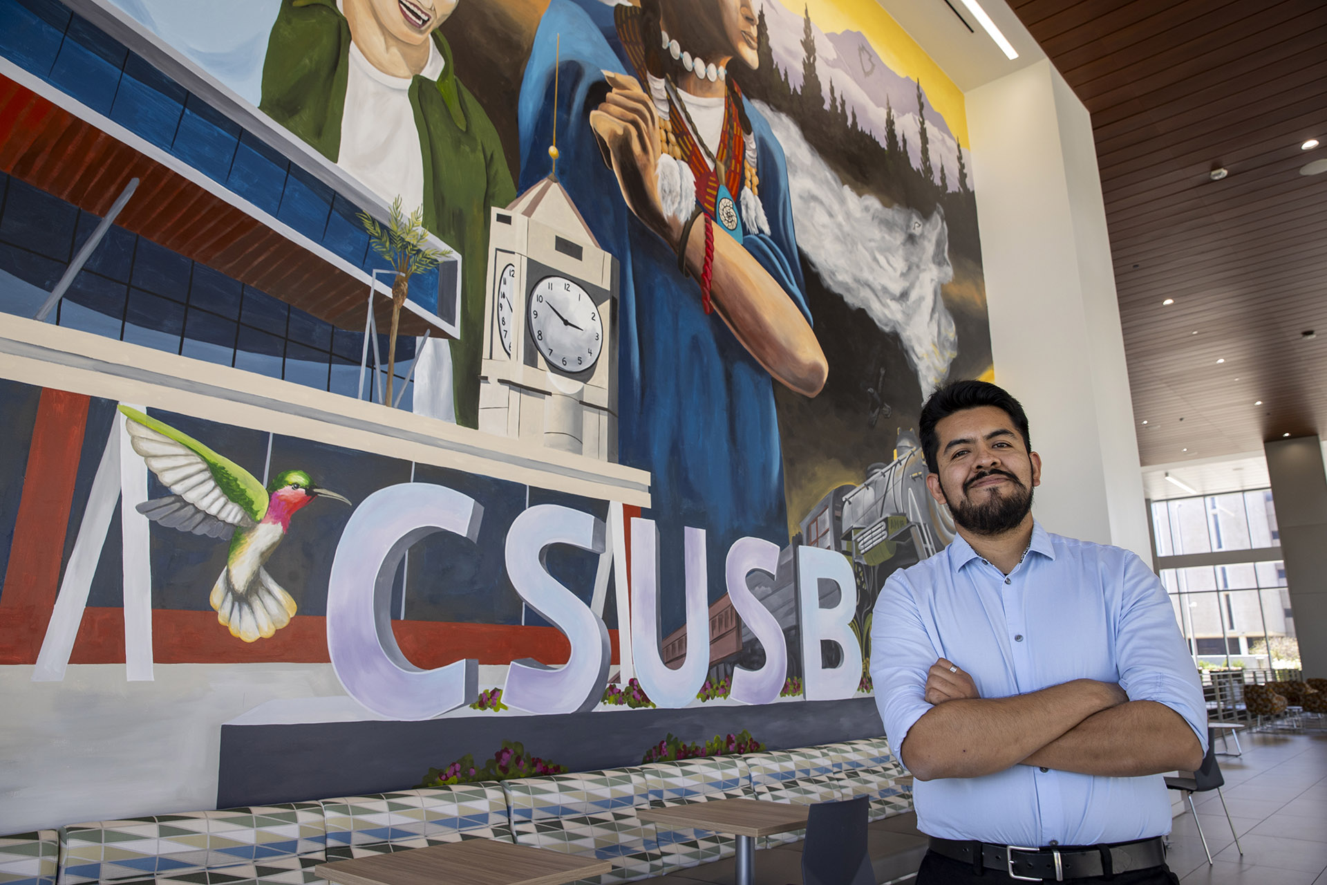 Luis Gonazlez by one of the murals at SMSU North.