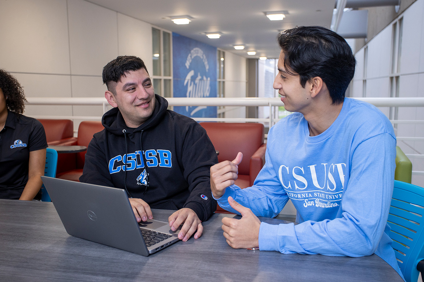 Two students at a laptop