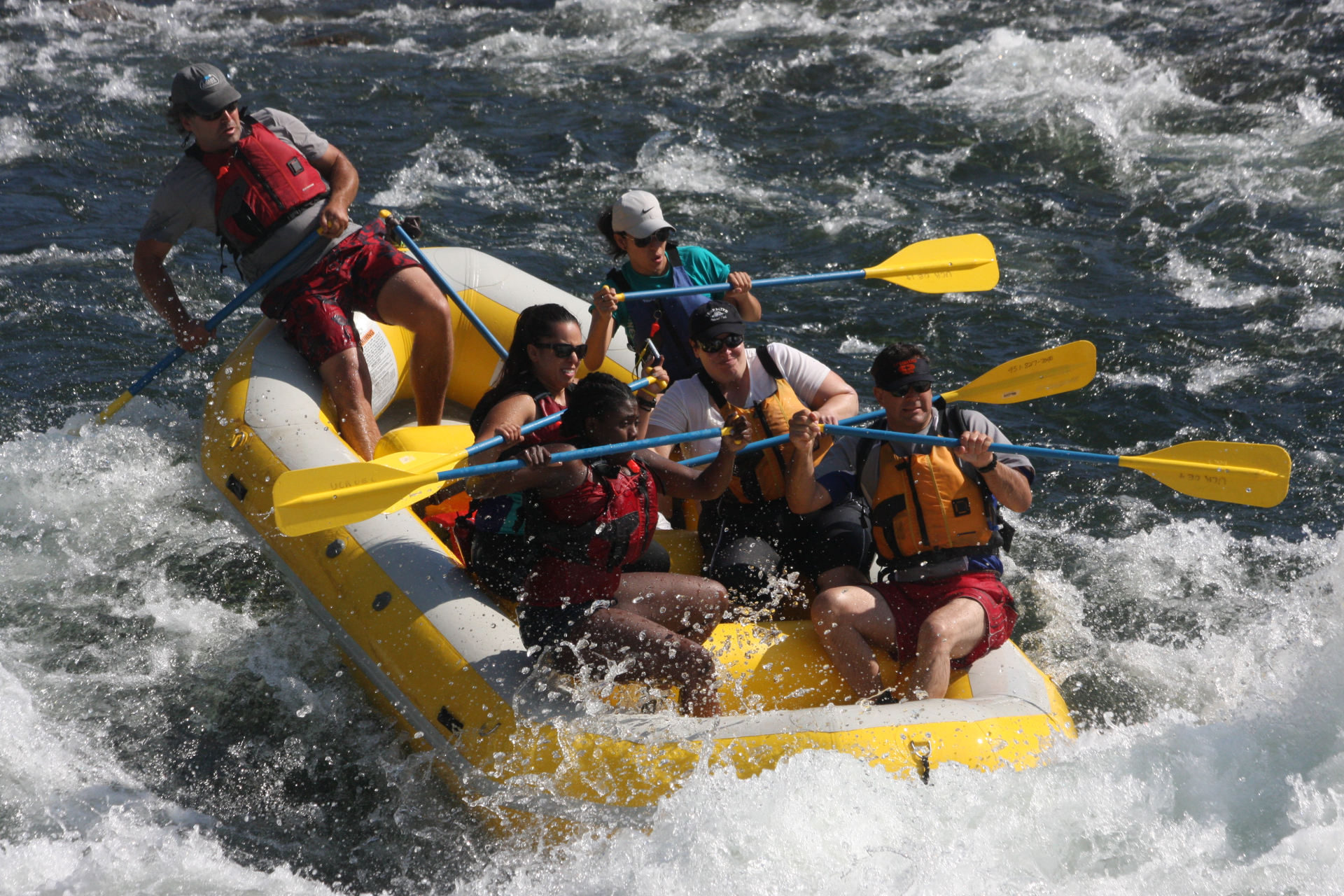 rafter entering big wave in yellow boat