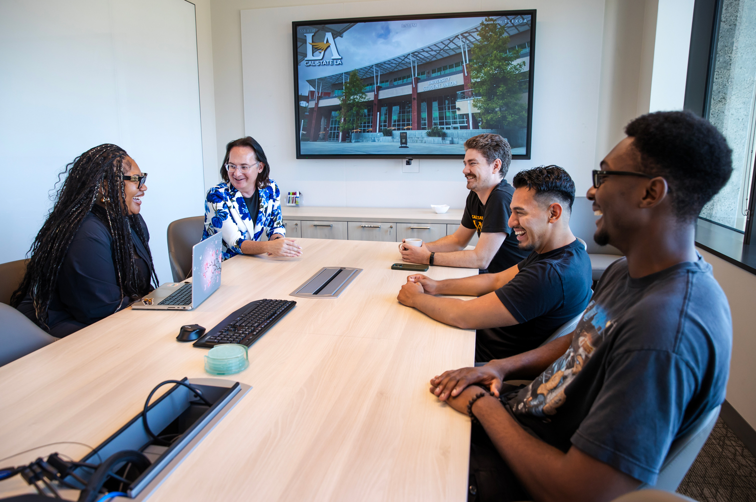 Hollins, second from left, meets with Strategic Communications team members at Cal State LA.
