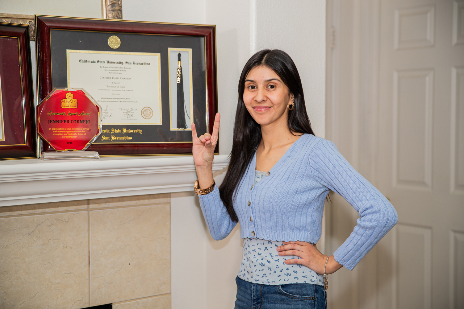 Cornejo with her diploma in the background