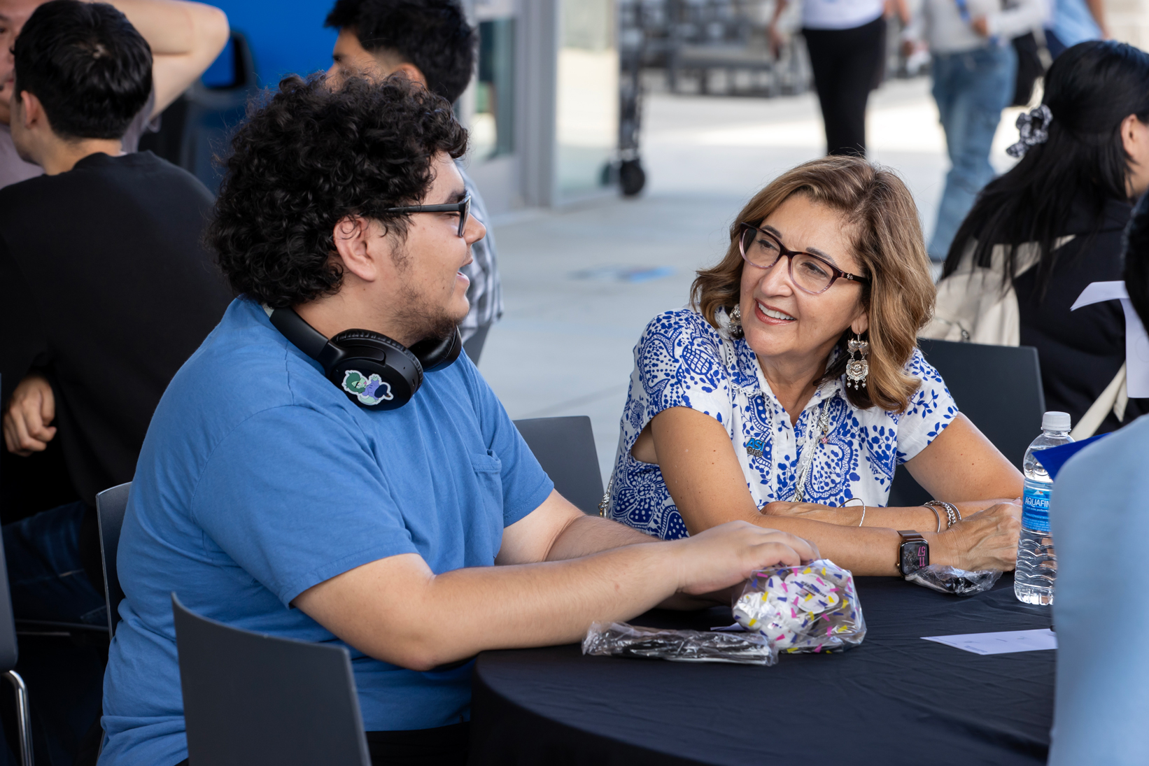CSUSB President Terri Gomez (at right) talks with a student.