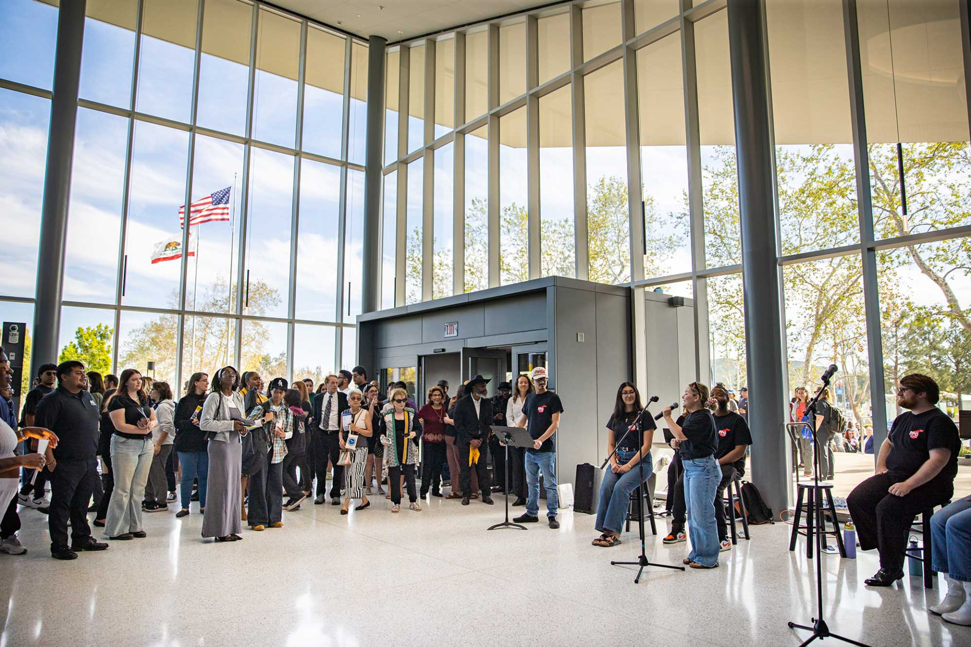 Students performing in the Ellen and Stan Weisser Foyer as guests tour the new Performing Arts Center.