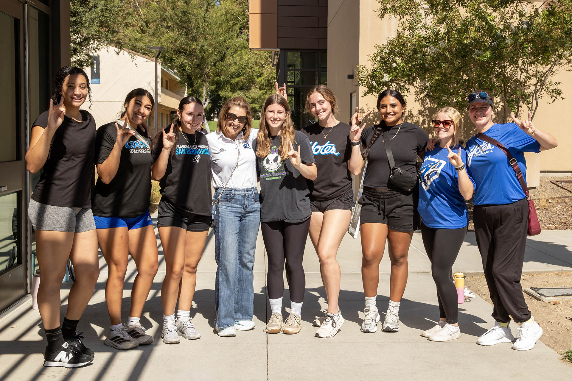 President Terri Gomez (center in white shirt) joined students at the Aug. 22 Move-in Day.