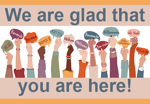 We are glad that you are here?  Hands hold up welcome signs in many languages.