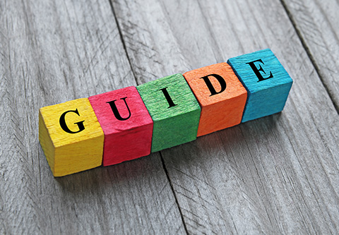 Colorful wooden blocks spell out “Guide”.